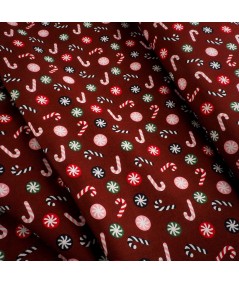 Popelín navideño rojo con bastones de caramelo y bolas navideñas