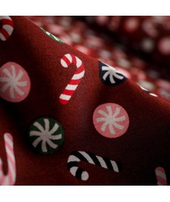 Popelín navideño rojo con bastones de caramelo y bolas navideñas